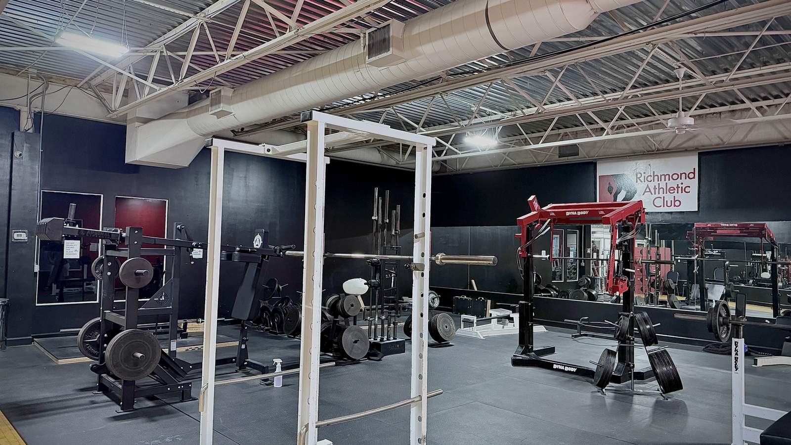 Squat racks and platforms in the strength room at Richmond Athletic Club